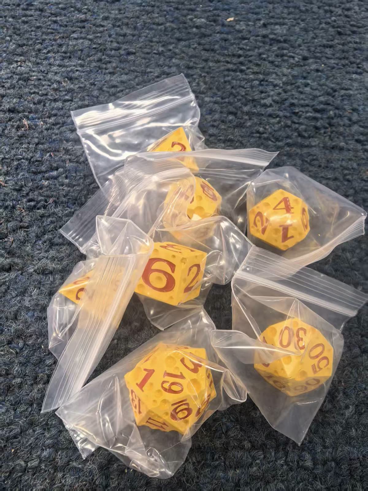 Black dragon-themed die-cast metal dice with embossed scale relief and contrasting numerals